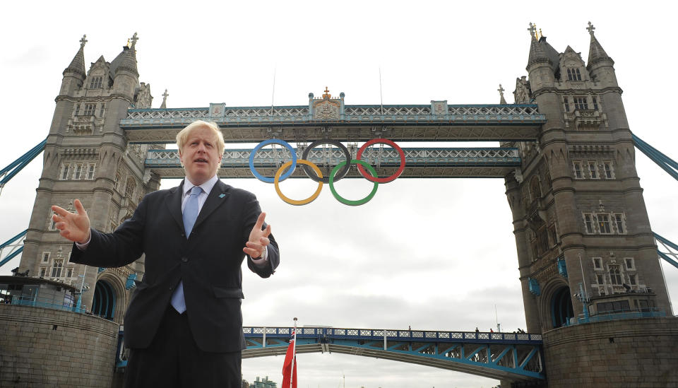 London Mayor Boris Johnson in front of Tower Bridge in London where the Olympic rings were hung this morning in readiness for the start of the 2012 Lodnon Olympics.