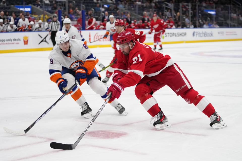 Detroit Red Wings' Dylan Larkin (71) drives past New York Islanders' Noah Dobson during the first period of an NHL hockey game, Monday, Oct. 30, 2023, in Elmont, N.Y. (AP Photo/Frank Franklin II)