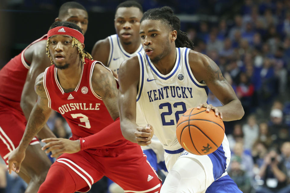 Kentucky's Cason Wallace (22) drives on Louisville's El Ellis (3) during the second half of an NCAA college basketball game in Lexington, Ky., Saturday, Dec. 31, 2022. Kentucky won 86-63. (AP Photo/James Crisp)