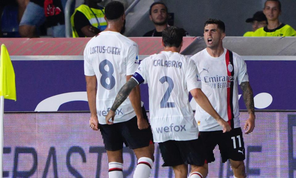 Christian Pulisic, right, celebrates his first Serie A goal with AC Milan teammates. (Danilo Di Giovanni/Getty Images)