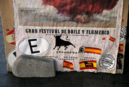 Stickers of Spanish flags and bulls can be seen on a banner in front of a souvenir shop in central Madrid, Spain, August 24, 2016. Picture taken August 24, 2016. REUTERS/Andrea Comas