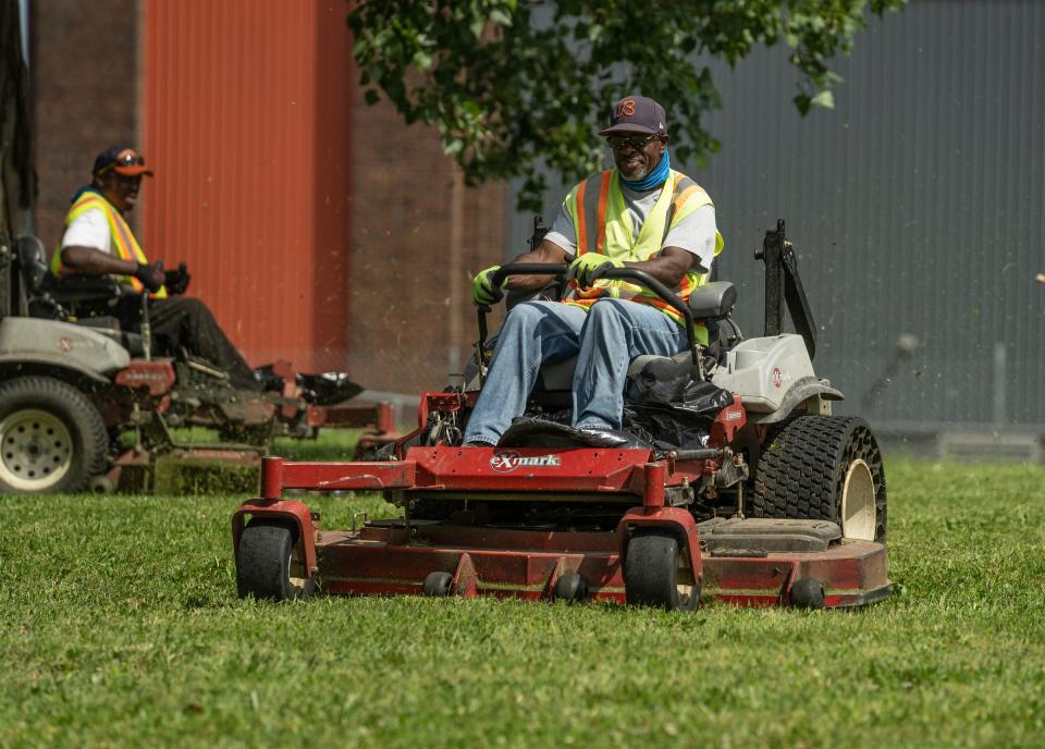 Payne Commercial Service Landscaping Inc. employee Phillip Mulligan Sr. drives a lawn mower while finishing a job on Detroit's east side on Thursday, June 16, 2022.