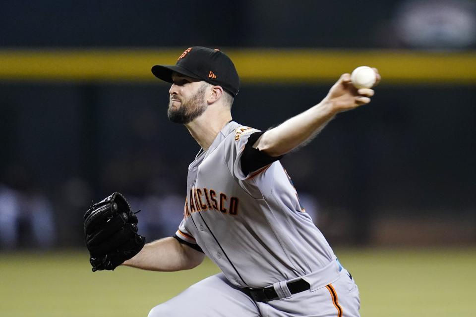 San Francisco Giants starting pitcher Alex Wood throws to an Arizona Diamondbacks batter during the first inning of a baseball game Tuesday, July 5, 2022, in Phoenix. (AP Photo/Ross D. Franklin)