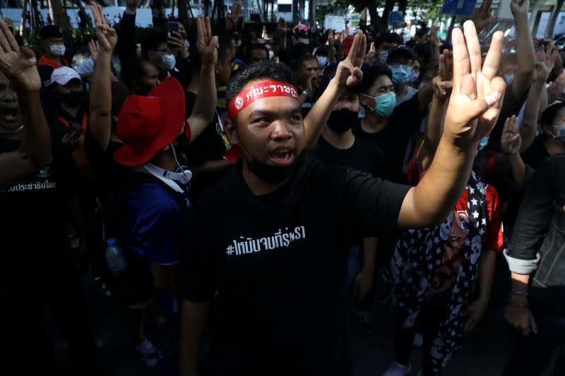 People show the three-finger salute in Bangkok