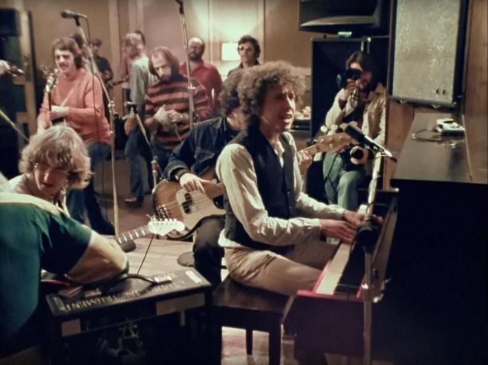 Bob Neuwirth, in orange turtleneck, with Bob Dylan at the piano in a still from Martin Scorsese’s 2019 documentary Rolling Thunder Revue: A Bob Dylan Story, 2019.