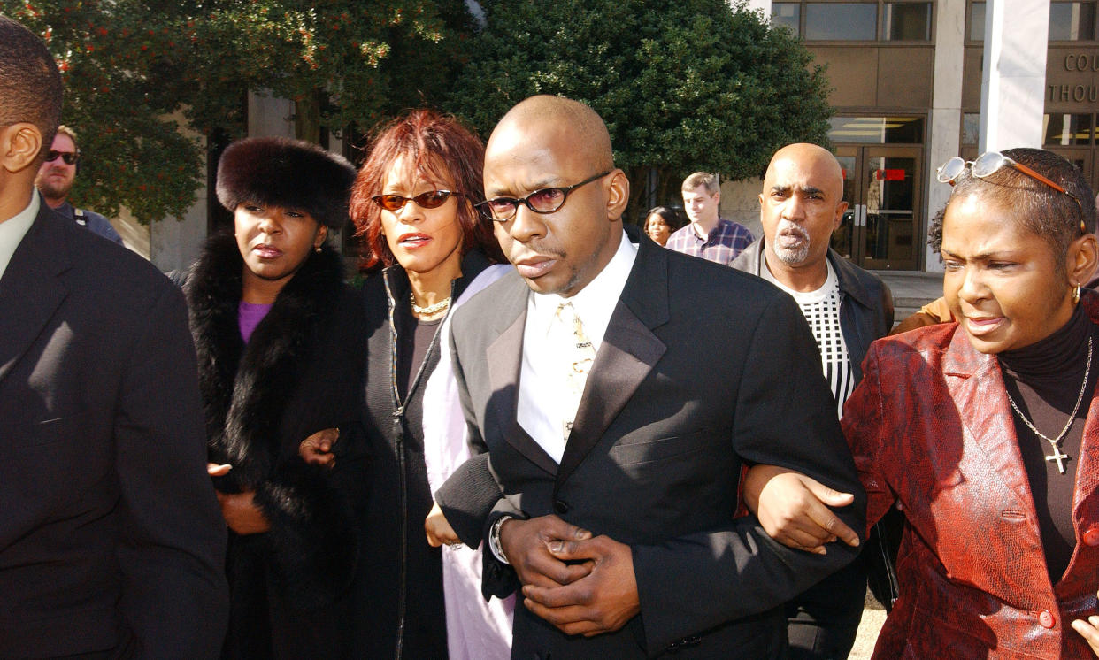 DECATUR, GA - NOVEMBER 25:  Singer Whitney Houston and her husband Bobby Brown (C) leave the Dekalb County Courthouse after a hearing stemming from Brown's 1996 traffic violations November 25, 2002 in Decatur, Georgia. A motion to dismiss the charges was denied and Brown's trial is scheduled for January 21, 2003.  (Photo by Frank Mullen/Getty Images)