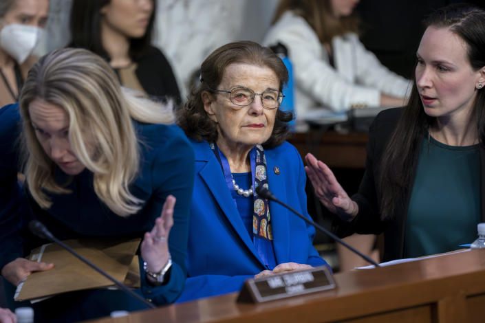 FILE - Sen. Dianne Feinstein, D-Calif., is flanked by aides as she returns to the Senate Judiciary Committee following a more than two-month absence as she was being treated for a case of shingles, at the Capitol in Washington, Thursday, May 11, 2023. Feinstein’s office said Thursday, May 18, that she is suffering from Ramsay Hunt syndrome, a complication from the shingles virus that can paralyze part of the face, and that she contracted encephalitis while recovering from the virus earlier this year. (AP Photo/J. Scott Applewhite, File)