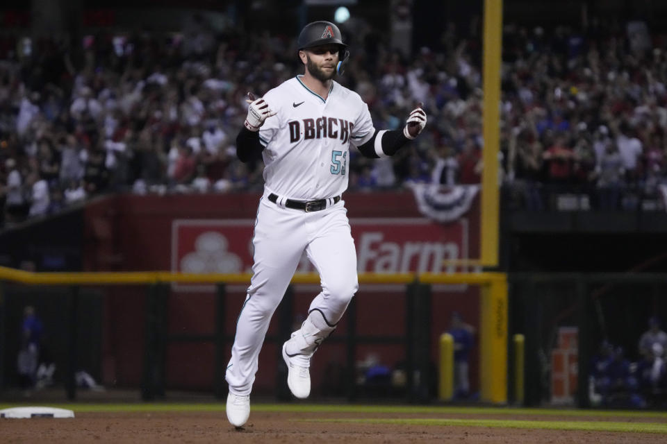 Arizona Diamondbacks' Christian Walker celebrates after hitting a home run during the third inning in Game 3 of a baseball NL Division Series against the Los Angeles Dodgers, Wednesday, Oct. 11, 2023, in Phoenix. (AP Photo/Rick Scuteri)