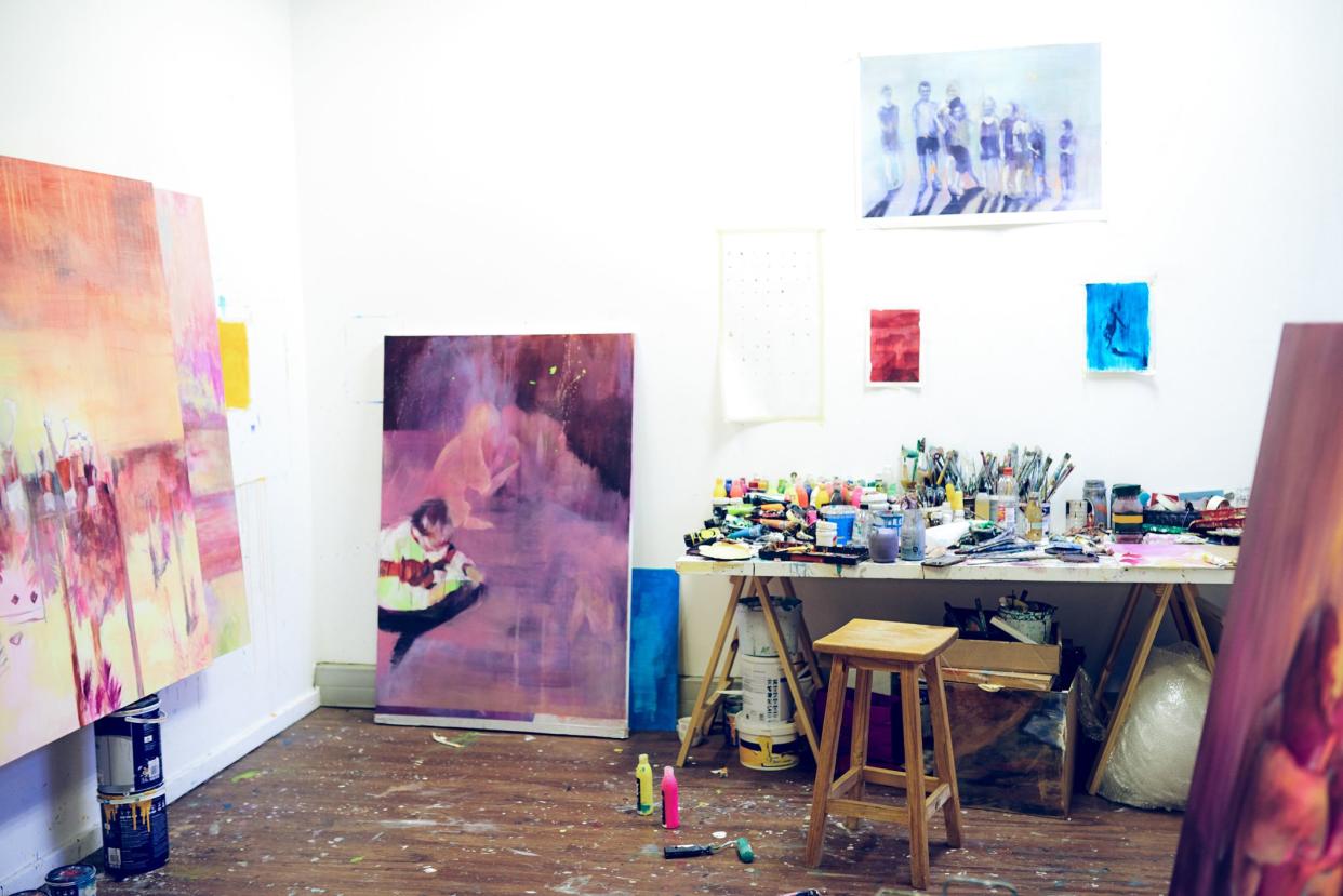 Still life shot of paintings and paintbrush sets inside an art studio