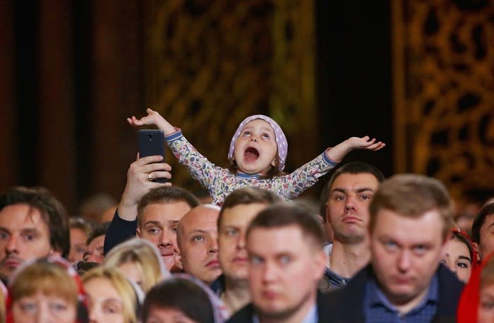 Getty photographer Mikhail Svetlov captured this young girl’s reaction at an Easter service for Russian Orthodox believers on April 8, 2018. <a href="https://www.theatlantic.com/photo/2018/04/photos-of-the-week-walls-whales-the-pope-and-a-llama/557960/" rel="nofollow noopener" target="_blank" data-ylk="slk:See more of the week’s best photos.;elm:context_link;itc:0;sec:content-canvas" class="link ">See more of the week’s best photos.</a>