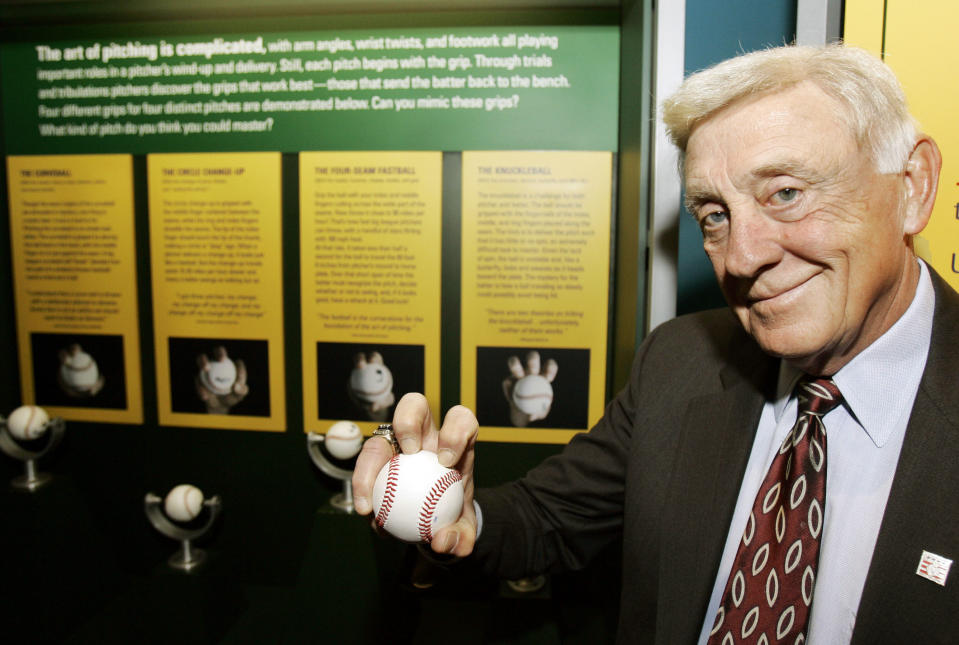 FILE - In this March 29, 2007, file photo, Baseball Hall of Famer Phil Niekro holds a knuckleball at the Great Lakes Science Center in Cleveland. Niekro, who pitched well into his 40s with a knuckleball that baffled big league hitters for more than two decades, mostly with the Atlanta Braves, has died after a long fight with cancer, the team announced Sunday, Dec. 27, 2020. He was 81. (AP Photo/Tony Dejak, File)