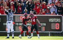 Calgary Stampeders' Keenan MacDougall, right, celebrates his interception touchdown with teammate Quincy Butler during first half CFL football action against the Montreal Alouettes in Calgary, Alta., Sunday, July 1, 2012. THE CANADIAN PRESS/Jeff McIntosh