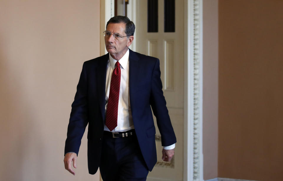 FILE - In this Oct. 3, 2018, file photo, Sen. John Barrasso, R-Wyo., heads to the Senate floor in Washington. Recent California earthquakes that rattled Las Vegas have shaken up arguments by proponents and opponents of a stalled federal plan to entomb nuclear waste beneath a long-studied former volcanic ridge in southern Nevada. The Las Vegas Review-Journal reports that Wyoming Republican Sen. John Barrasso said this week his legislation to jumpstart the process to open Yucca Mountain is based on studies that take seismic activity into account. Nevada officials disagree. (AP Photo/Alex Brandon)