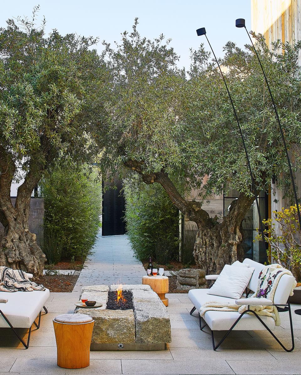 A bespoke granite firepit centers the courtyard.