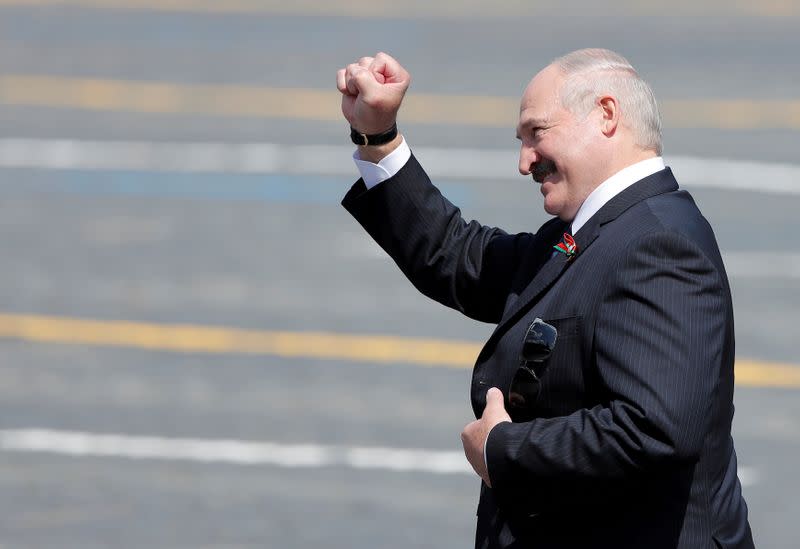 FILE PHOTO: Belarusian President Alexander Lukashenko gestures as he leaves after the Victory Day Parade in Red Square in Moscow