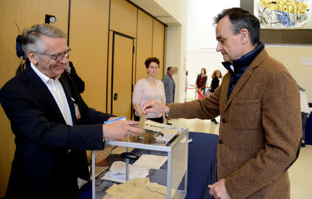 French Ambassador to the U.S. Gerard Araud (R) casts his ballot as he joins French citizens living in the United States voting in the French presidential run-off between Emmanuel Macron and Marine Le Pen, at the French Embassy in Washington, U.S., May 6, 2017. REUTERS/Mike Theiler