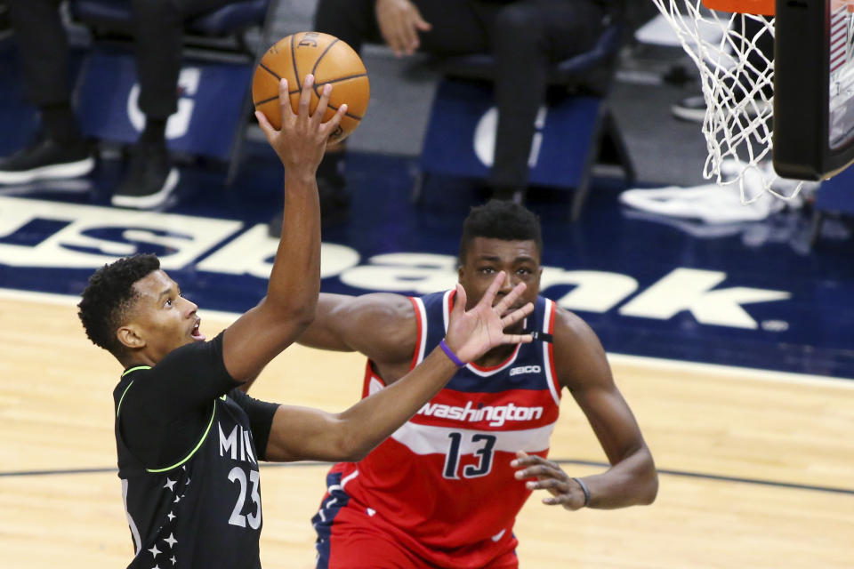 Minnesota Timberwolves guard Jarrett Culver (23) shoots next to Washington Wizards forward Thomas Bryant (13) during the second quarter of an NBA basketball game Friday, Jan. 1, 2021, in Minneapolis. (AP Photo/Andy Clayton-King)