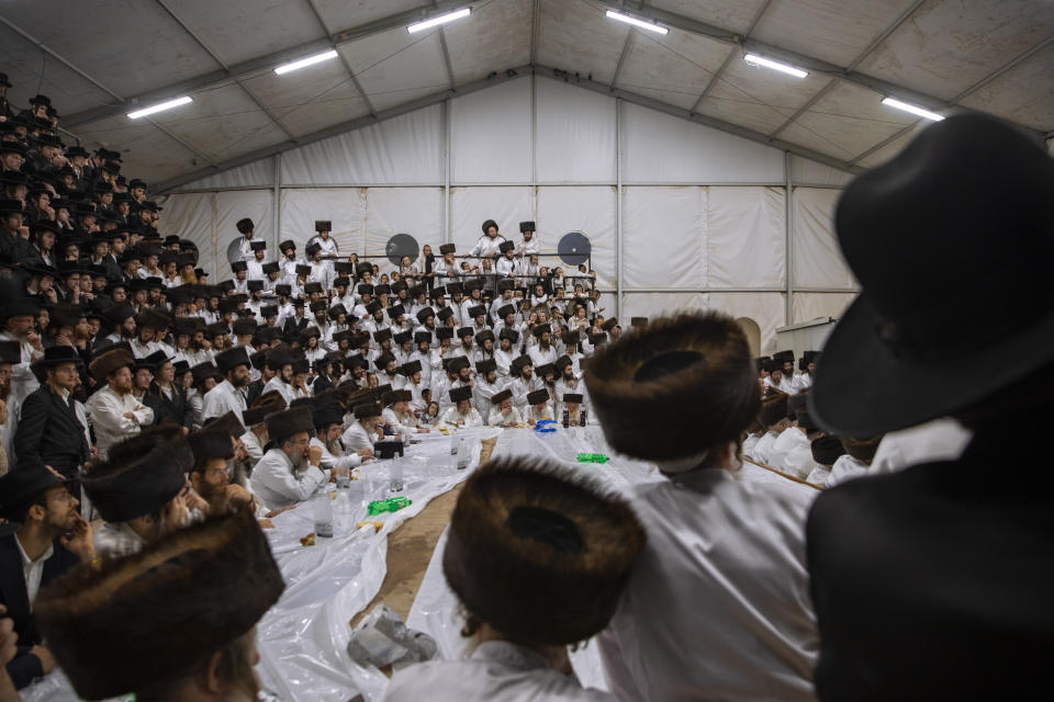 Ultra-Orthodox Jews, members of the Lelov Hassidic dynasty attend the "Pidyon Haben" ceremony for the great grandchild of their chief rabbi Aharon Biderman in Beit Shemesh, Israel, Thursday, Sept. 16, 2021. The Pidyon Haben, or redemption of the firstborn son, is a Jewish ceremony hearkening back to the biblical exodus from Egypt. (AP Photo/Oded Balilty)