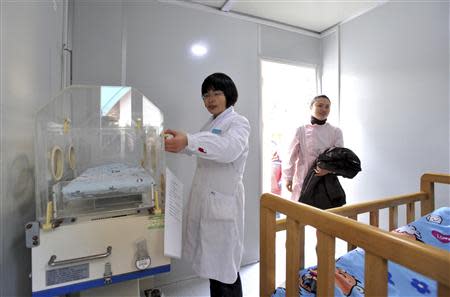 Staff of local institute of children's welfare work inside a baby hatch in Nanjing, Jiangsu province December 11, 2013. REUTERS/Stringer