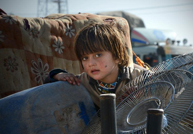 A Pakistani internally displaced child who fled the military operation against Taliban militants, arrives at a registration point in Peshawar, on November 14, 2014