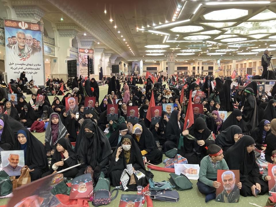 People attend a commemoration for the late Revolutionary Guard Gen. Qassem Soleimani, who was killed in a U.S drone attack in 2020 in Iraq, at the Imam Khomeini grand mosque in Tehran, Iran, Wednesday, Jan. 3, 2024. Iran says bomb blasts at an event in the city of Kerman, honoring a prominent Iranian general slain in a U.S. airstrike in 2020, have killed at least 103 people and wounded 188 others. (AP Photo/Vahid Salemi)
