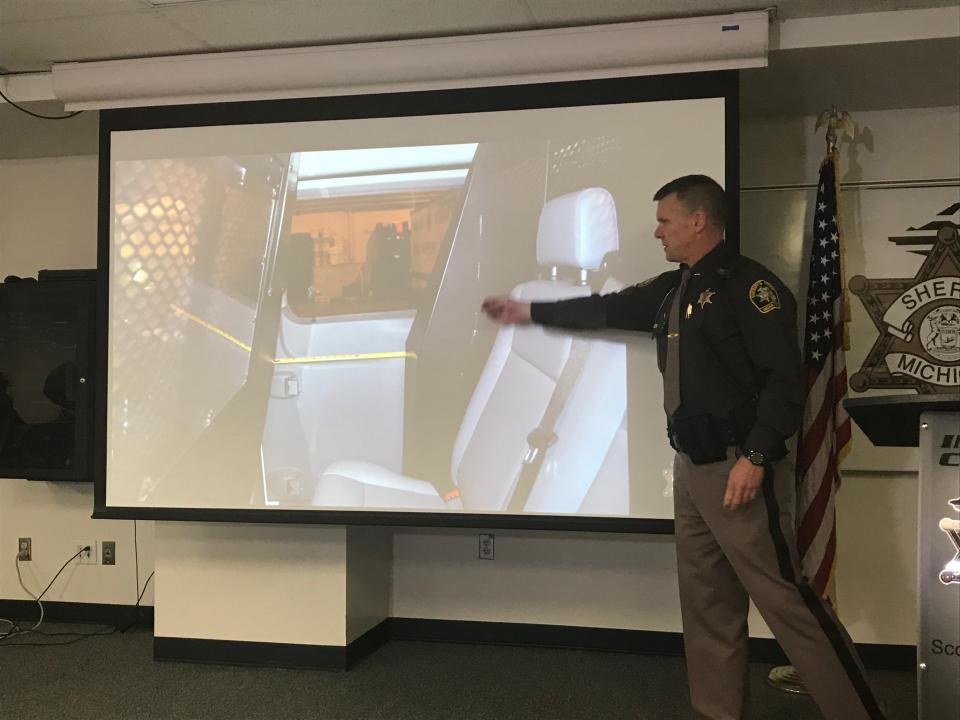 Ingham County Sheriff Scott Wriggelsworth points to a photo of the transport van that Marquis Oliver was riding in when he opened the side door and jumped out. Wriggelsworth spoke at a press conference Dec. 31, 2019, to discuss the results of an investigation into Oliver's death.