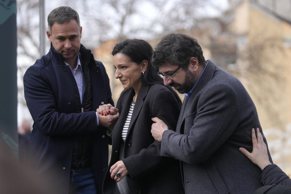 Marinika Tepic, center, a member of the Serbia Against Violence coalition, who is currently on hunger strike, is helped on stage during a demonstration downtown Belgrade, Serbia, Saturday, Dec. 30, 2023. Thousands of people gathered to protest what election observers said were widespread vote irregularities during a recent general election. (AP Photo/Darko Vojinovic)