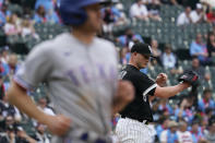 Chicago White Sox relief pitcher Matt Foster, right, waits as Texas Rangers' Brad Miller heads to first with a walk during the 10th inning of a baseball game in Chicago, Saturday, June 11, 2022. The Rangers won 11-9 in 10 innings (AP Photo/Nam Y. Huh)