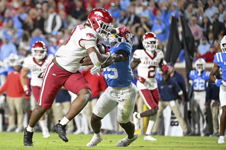 Arkansas tight end Ty Washington, front left, fights past Mississippi safety Trey Washington (25) for a 17-yard touchdown during the second half of an NCAA college football game in Oxford, Miss., Saturday, Oct. 7, 2023. (AP Photo/Thomas Graning)