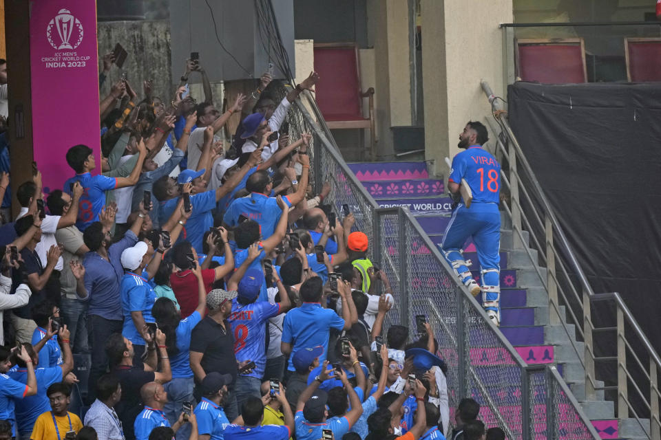 India's Virat Kohli gets a standing ovation from the fans as he walks back to the pavilion after losing his wicket during the ICC Men's Cricket World Cup first semifinal match between India and New Zealand in Mumbai, India, Wednesday, Nov. 15, 2023. (AP Photo/Rajanish Kakade)