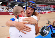 <p>Jonathan Milan of Team Italy is congratulated by his coach Marco Villa after winning the gold medal and setting a new World record during the Men's cycling team pursuit finals at Izu Velodrome on August 4.</p>