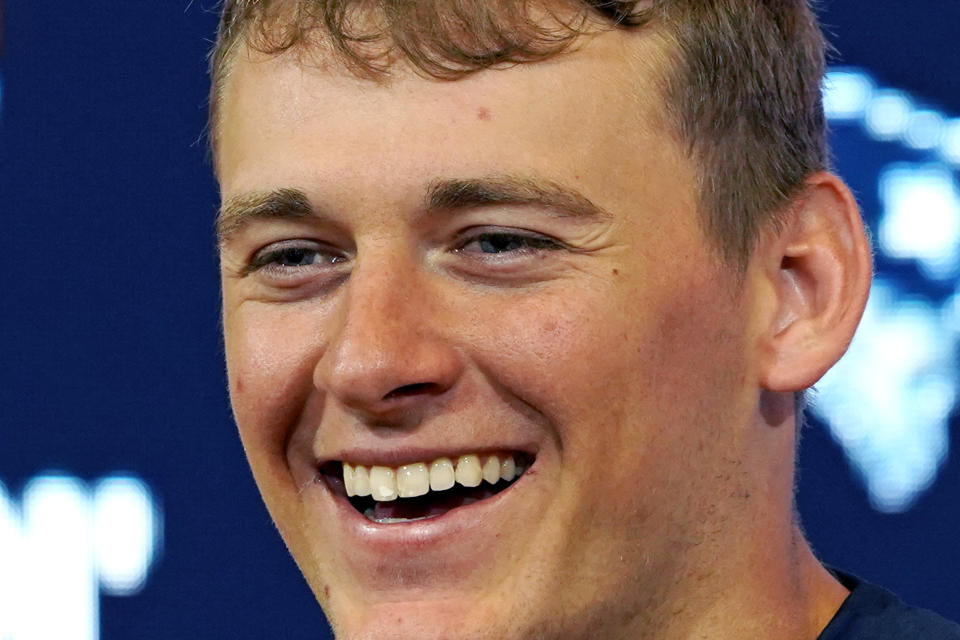 New England Patriots quarterback Mac Jones smiles while talking with reporters during a news conference following an NFL football game, Sunday, Oct. 24, 2021, in Foxborough, Mass. The Patriots defeated the New York Jets 54-13, for Jones' first home season win. (AP Photo/Mary Schwalm)