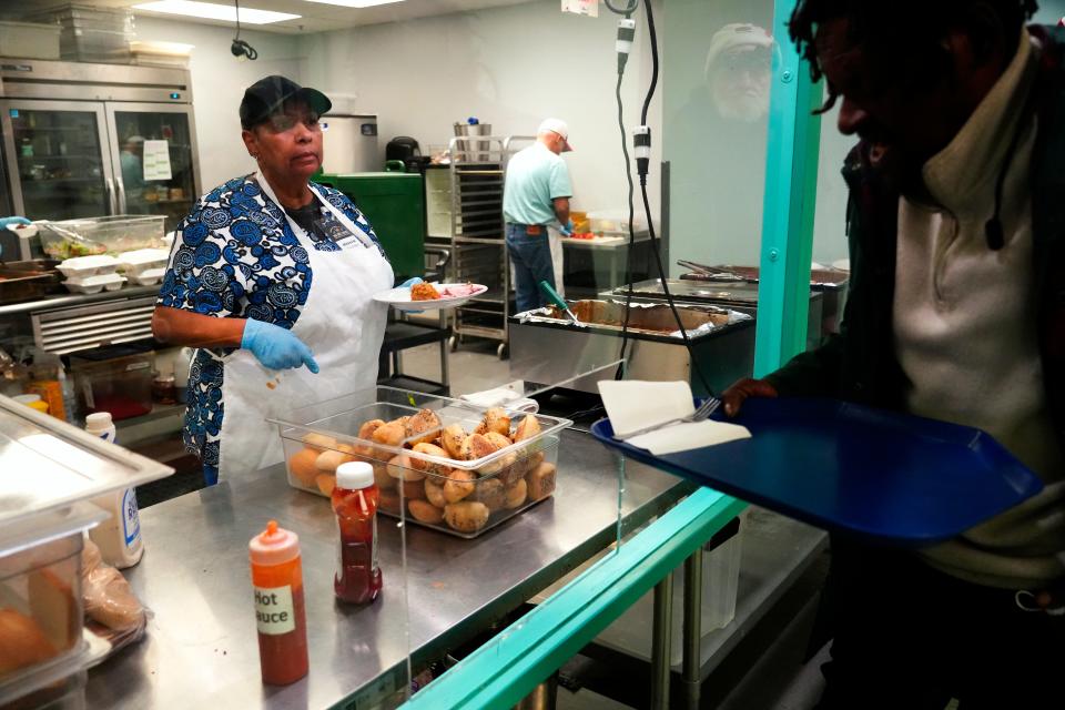 A volunteer serves food at Our Daily Bread in Over-the-Rhine. The nonprofit takes surveys of those who use its services. In 2023, the self-reports showed 30% of their clients were housed, 70% were homeless and 40% were unsheltered. It’s an increase from pre-pandemic numbers.