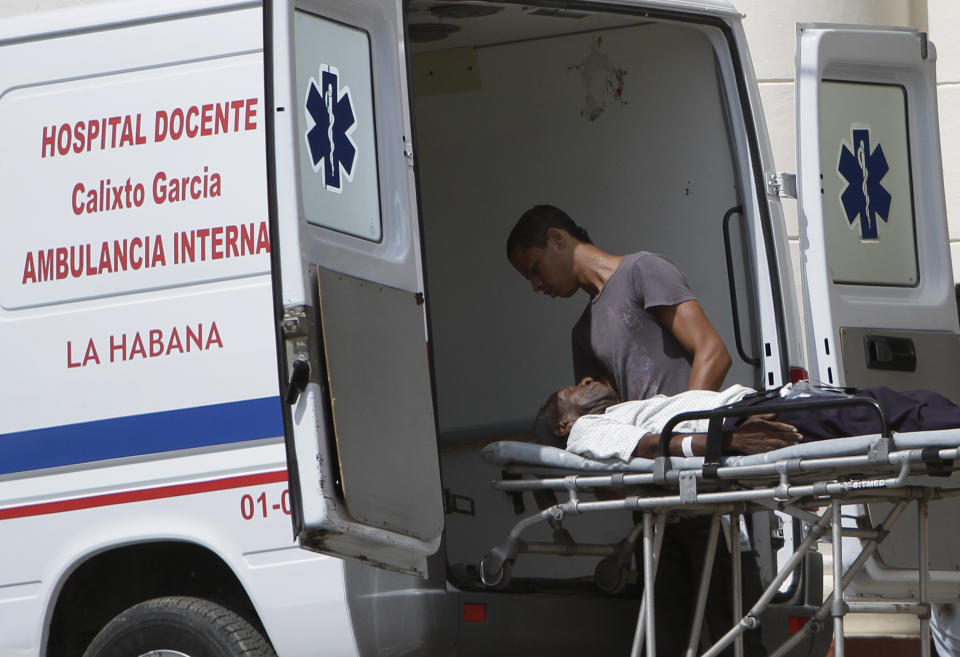 In this Aug 13, 2012 photo, a sick man is taken by ambulance to the public hospital Calixto Garcia in Havana, Cuba. Cuba's system of free medical care, long considered a birthright by its citizens and trumpeted as one of the communist government's great successes, is not immune to cutbacks under Raul Castro's drive for efficiency. The health sector has already endured millions of dollars in budget cuts and tens of thousands of layoffs, and Castro is looking for more ways to save. (AP Photo/Franklin Reyes)