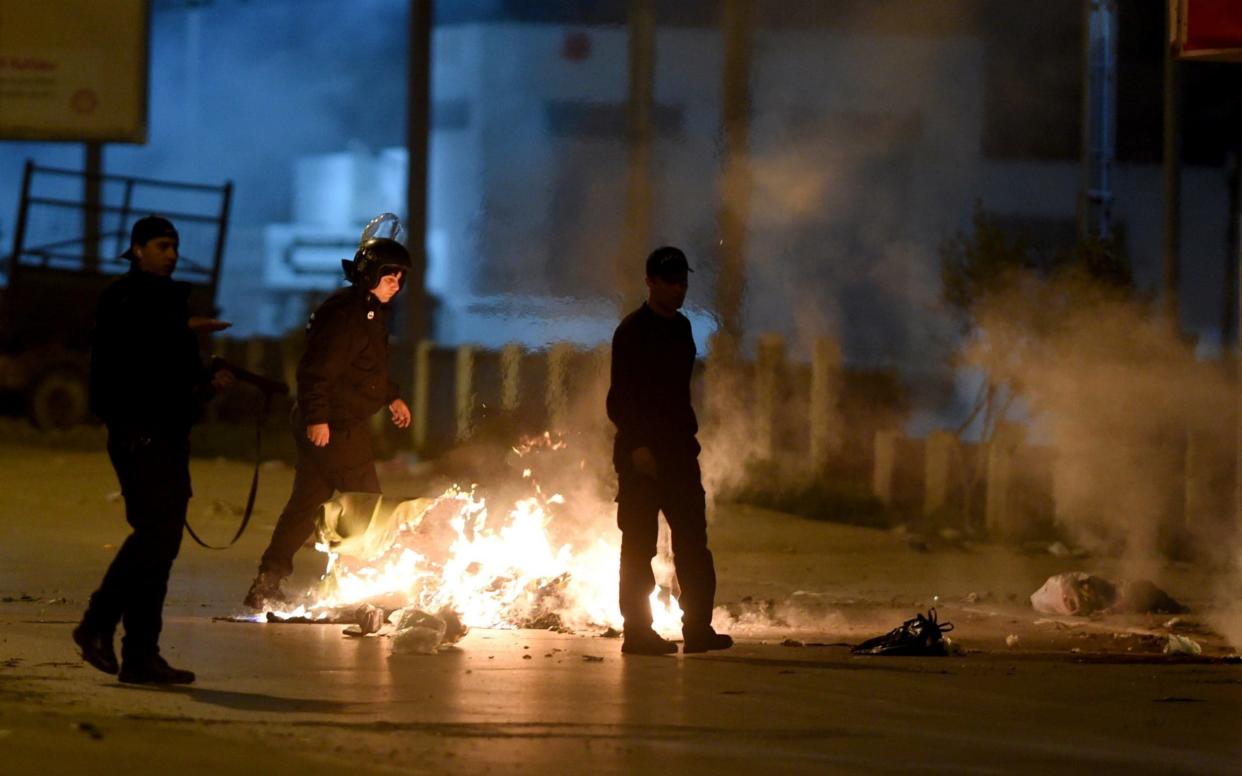 Tunisian security forces in the Ettadhamen on the outskirts of Tunis late on January 10, - AFP