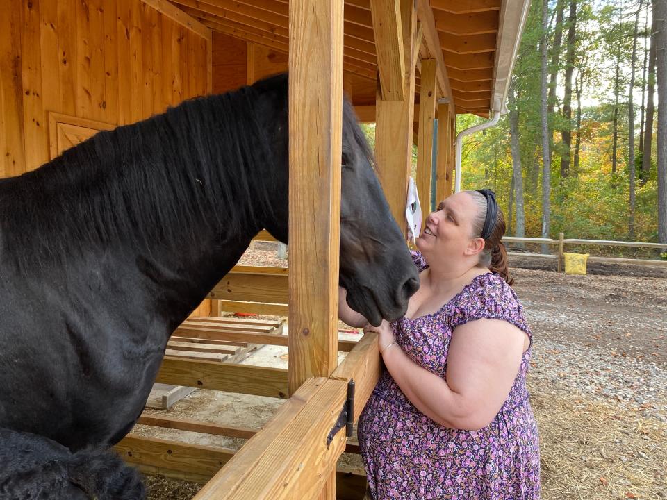 Angel Burge of Fall River visits her favorite horse, Midnight, along with Midnight's baby, Zara, at Deep Pond Farm & Stables in Taunton on Friday, Oct. 6, 2023. Burge describes these trips as therapeutic for her as she deals with health challenges.