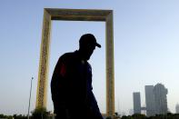 FILE - A man passes in front of the Dubai Frame in Dubai, United Arab Emirates, June 29, 2023. Dubai hosts the United Nations COP28 climate talks starting Nov. 30. (AP Photo/Kamran Jebreili, File)