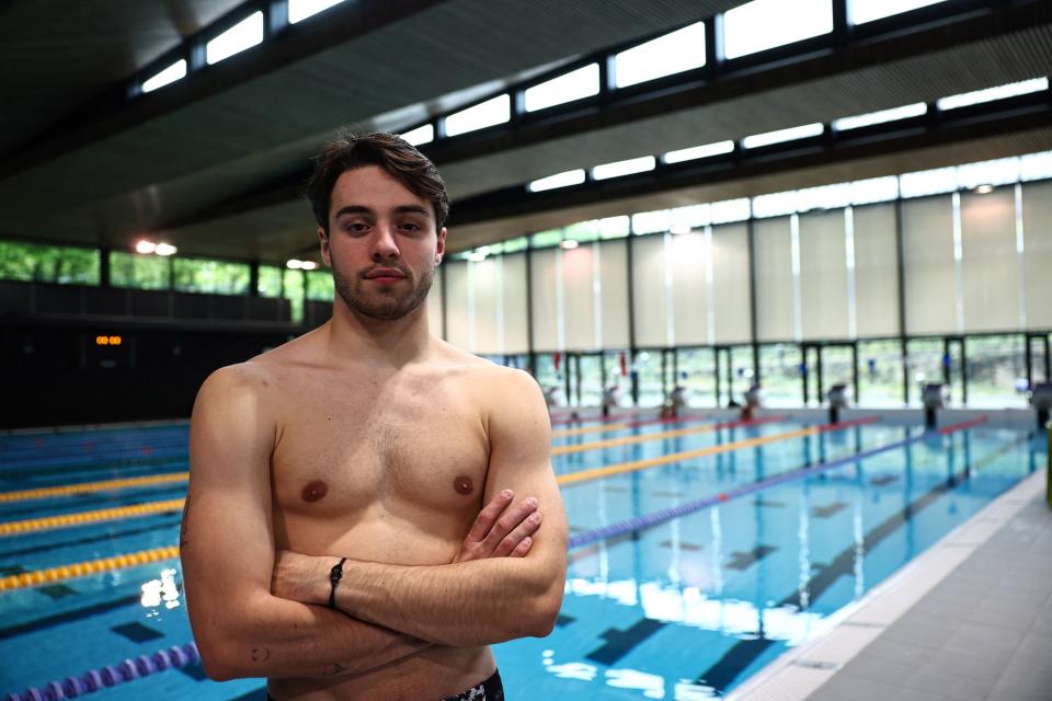 Frenchman Jules Bouyer stands next to a swimming pool.