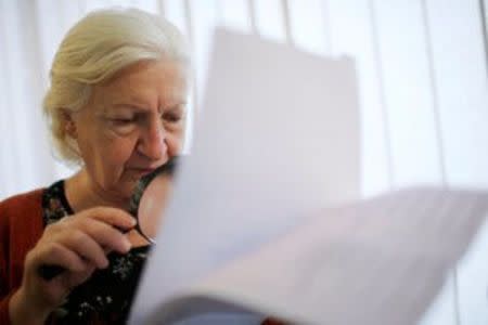 A woman studies the ballots during the parliamentary election in Tbilisi, Georgia, October 8, 2016. REUTERS/David Mdzinarishvili