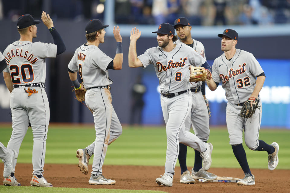 Detroit Tigers' Spencer Torkelson (20), Nick Maton (9), Matt Vierling (8), Jonathan Schoop (7) and Ryan Kreidler (32) celebrate after defeating the Toronto Blue Jays in baseball game action in Toronto, Thursday, April 13, 2023. (Cole Burston/The Canadian Press via AP)