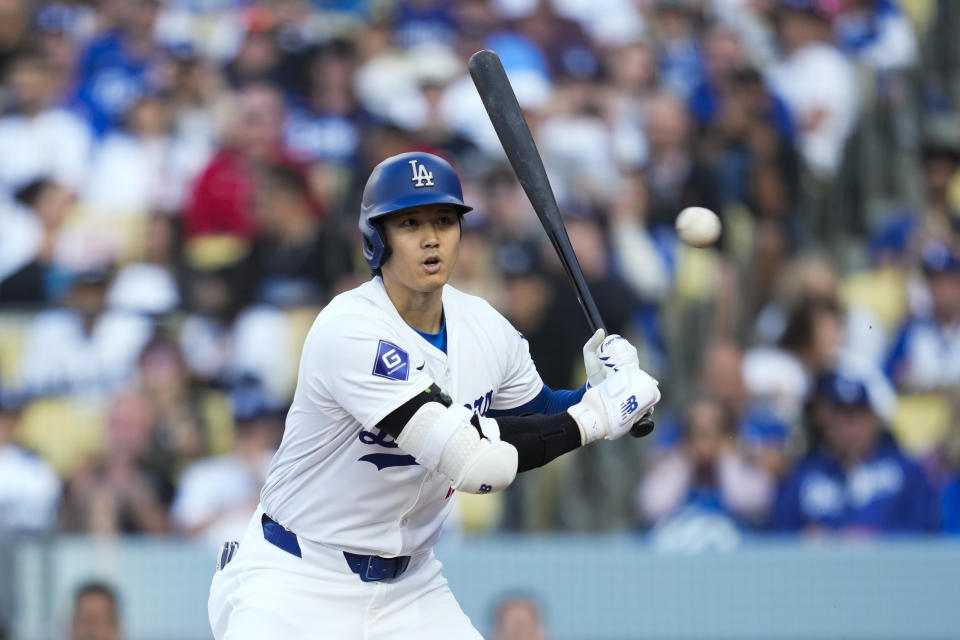 Los Angeles Dodgers designated hitter Shohei Ohtani reacts to a pitch during the first inning a baseball game against the Cincinnati Reds in Los Angeles, Saturday, May 18, 2024. (AP Photo/Ashley Landis)