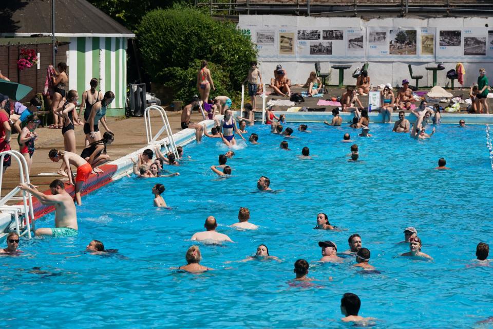 People enjoy the hot weather at Jesus Green Lido in Cambridge (Jacob King/PA)