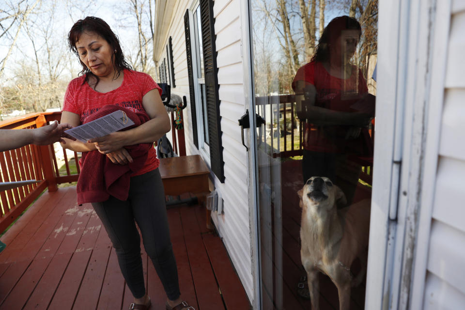 Marta Lagunes Hernandez, 49, who is originally from Mexico and whose son is a registered voter, talks with Ricky Hurtado, a Democratic candidate for the North Carolina state house, as he canvasses in a largely Latino trailer community, in Burlington, N.C., Sunday, March 8, 2020. (AP Photo/Jacquelyn Martin)