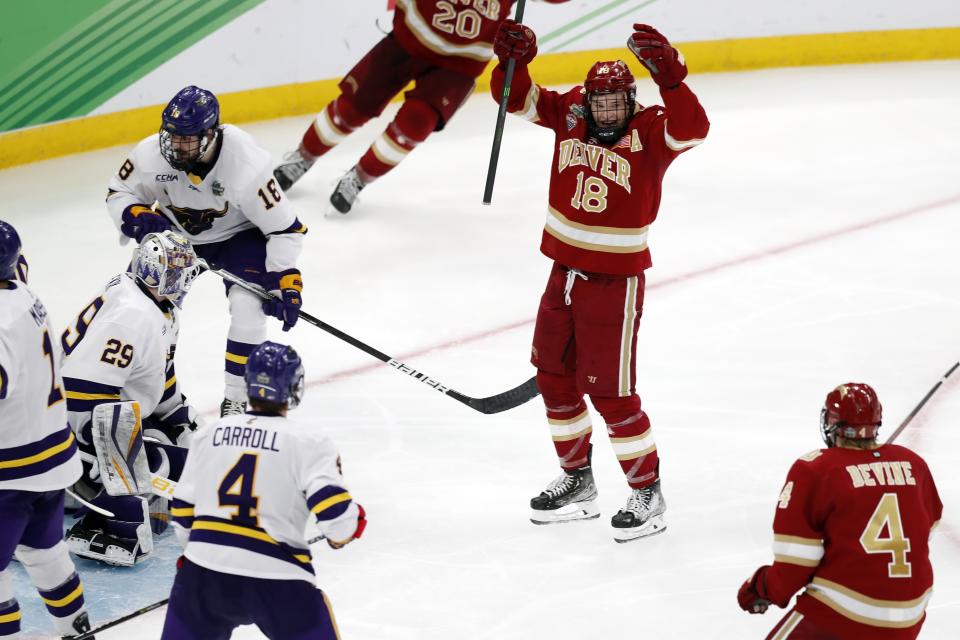 Denver's Ryan Barrow (18) celebrates his goal against Minnesota State during the third period of the NCAA men's Frozen Four championship college hockey game Saturday, April 9, 2022, in Boston. (AP Photo/Michael Dwyer)
