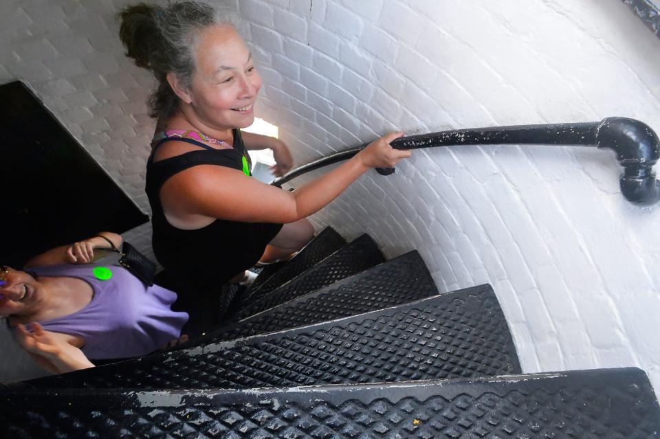 Angalina Speelman, top, and her friend, Loraine Hanson, climb the stairs inside the Presque Isle Lighthouse during a July 2022 visit.