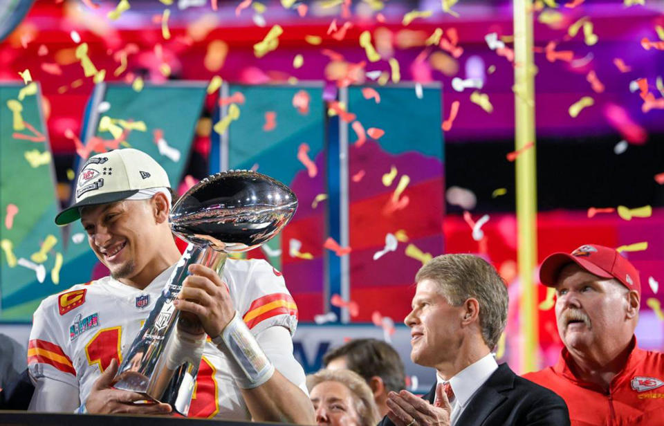 Kansas City Chiefs quarterback Patrick Mahomes (15) hoists the Lombardi Trophy after leading the Chiefs to a Super Bowl LVII victory, 38-35, over the Philadelphia Eagles on Sunday, Feb. 12, 2023, at State Farm Stadium in Glendale, Arizona. Chiefs Chairman & CEO Clark Hunt and head coach Andy Reid look on. (Tammy Ljungblad/The Kansas City Star/Tribune News Service via Getty Images)