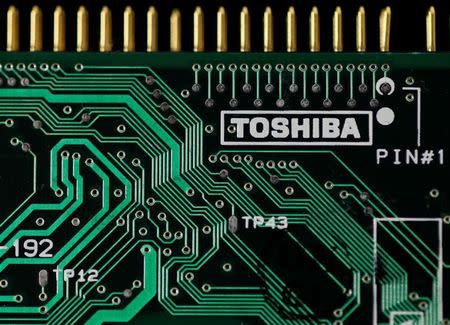 A logo of Toshiba Corp is seen on a printed circuit board in this photo illustration taken in Tokyo July 31, 2012. REUTERS/Yuriko Nakao/Files