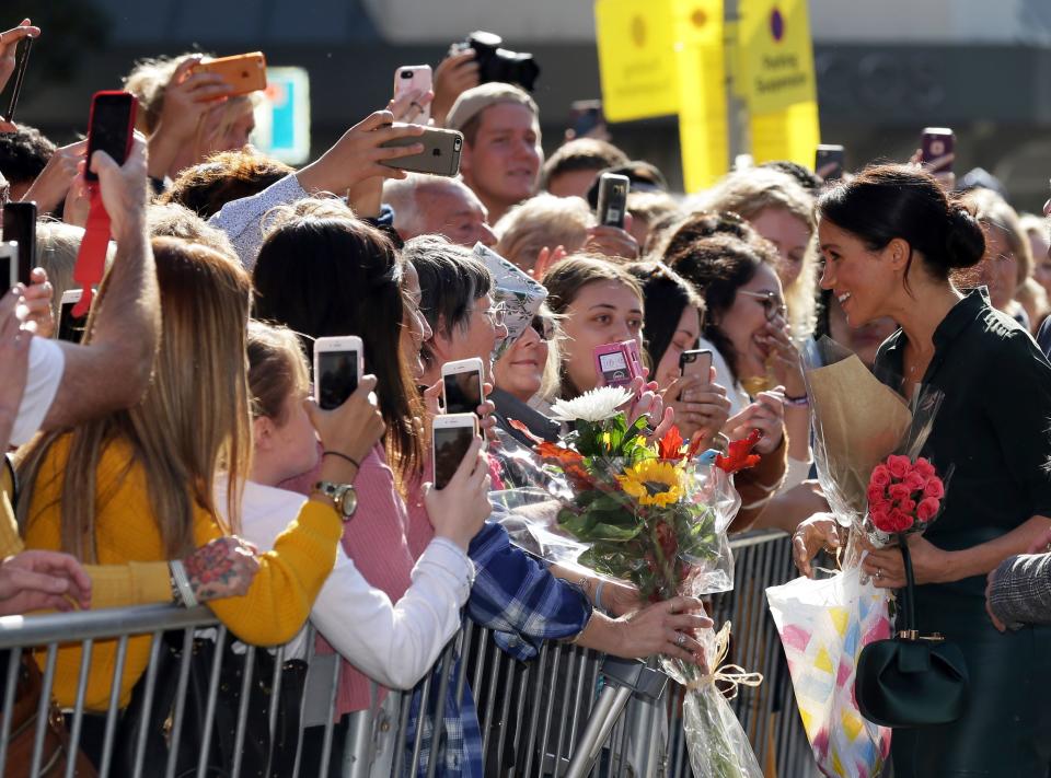 Britain's Meghan, Duchess of Sussex (R) speaks with well-wishers as she arrives to visit the Royal Pavilion in Brighton in East Sussex, southern England, on October 3, 2018. - The Duke and Duchess of Sussex made their first joint official visit to Sussex on October 3. Their Royal Highnesses paused to greet members of the public gathered at Pavilion Buildings on their way to the Royal Pavilion. (Photo by Tim IRELAND / POOL / AFP)        (Photo credit should read TIM IRELAND/AFP via Getty Images)