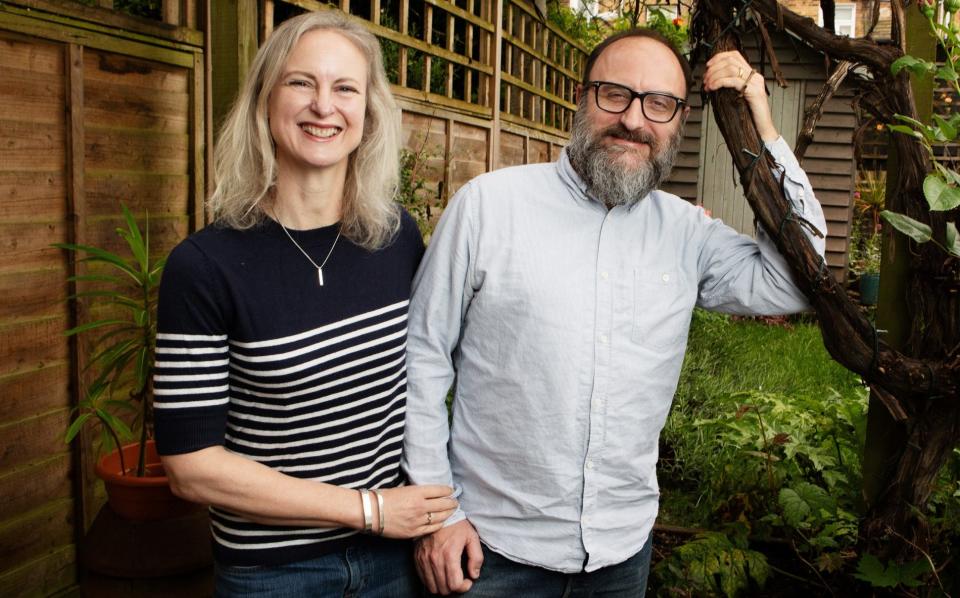 Lebby Eyres, 53, and her husband Fred Guetin, 48, are seen in their garden in London