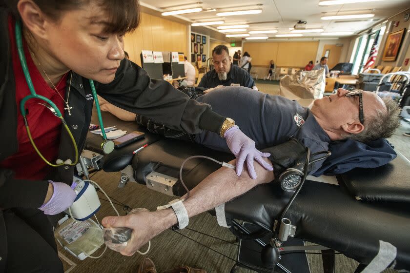 MALIBU, CA-JUNE 8, 2023: Phlebotomist Jingle Bustamante draws blood from Judd Stark during a blood drive at Malibu City Hall. Gay men, like Stark, are now allowed to give blood in the U.S. The FDA guidelines ease decades-old restrictions designed to protect the blood supply from HIV. (Mel Melcon / Los Angeles Times)